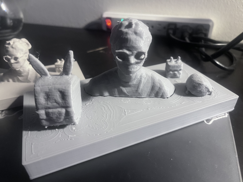 This final 3D-printed piece brings together three objects that hold personal significance to me—the card case, the power plug, and the Leon Kennedy plush—into a single physical form. Rather than representing my appearance, this work treats these objects as data that reflect my habits, dependencies, and cultural influences. Through scanning, modeling, and fabrication, the project translates personal experience into a tangible artifact, demonstrating how identity can be understood and expressed through objects, systems, and meaning rather than through a traditional visual portrait.